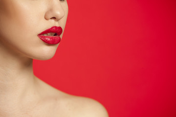 red glossy lipstick on red background