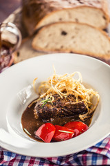 Confit beef steak with sauce fried onion bread draft beer and decoration in pub or restaurant