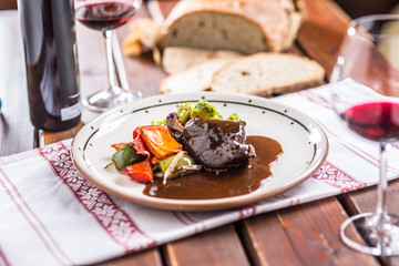 Confit rabbit leg with vegetable bread redvine in pub or restaurant