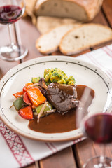 Confit rabbit leg with vegetable bread redvine in pub or restaurant