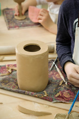 Fototapeta na wymiar Child sculpts the product from raw clay