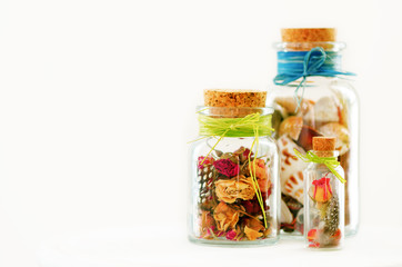 Sand and shells in bottle on white background. Free space for your text