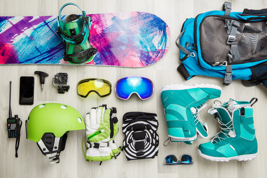 Photo of snowboarder objects on wooden background.