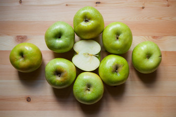 Many green large apples and cut slices