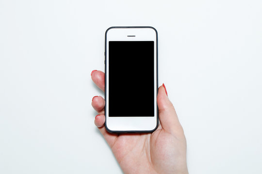 The Girl Is Holding A White Phone In Her Hand With Red Nails.