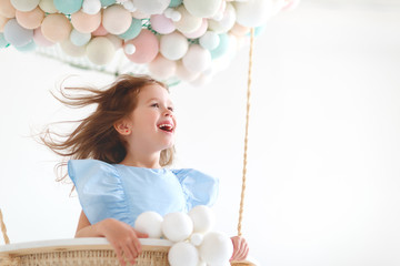 charming child girl in a fairy magic hot air balloon