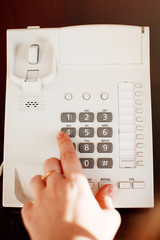 close-up partial view of woman calling by phone in hotel room