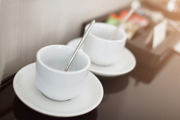 Two white empty espresso coffee cups on table, closeup