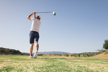 Professional golfer looking at ball after the swing
