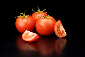 red tomatoes on a black background