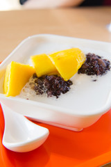 red bean balls and diced mango in coconut milk soup