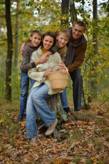 Fototapeta premium Happy smiling family in autumn forest 