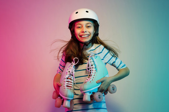 Young child girl in safety helmet with roller skates - sports