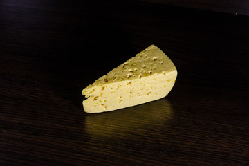 Piece of cheese on a wooden table