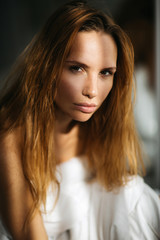 Naklejka premium Beautiful girl in bed with a blanket in her hands