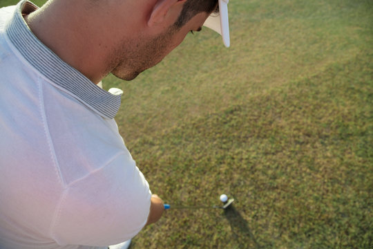 High angle view of golfer hitting a golf shot in the golf course