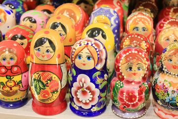 Fototapeta na wymiar Russian Matryoshka Nesting Dolls Set in Classic Clothes at Gift Shop Shelf. Stacking Women Figures Made of Wood and Painted in Various Colors is a Traditional Souvenir from Russia.