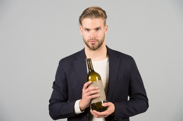 Boss with bottle of wine in hands. Bearded man hold alcoholic drink. Sommelier or degustator with wine. Alcohol addiction and bad habits. Winery degustation or drinking party concept