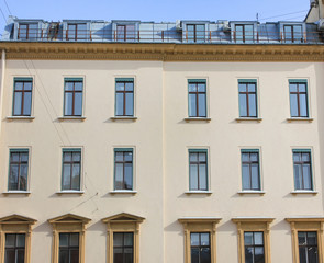 Obraz premium Classic Architecture Building Facade of Old Historical House with Soft Beige Colored Walls. Exterior Design and Elements of Apartment Building Front View. Minimalist Style European Architecture.
