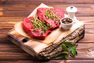 Fresh raw beef tenderloin and marbled steaks with seasoning