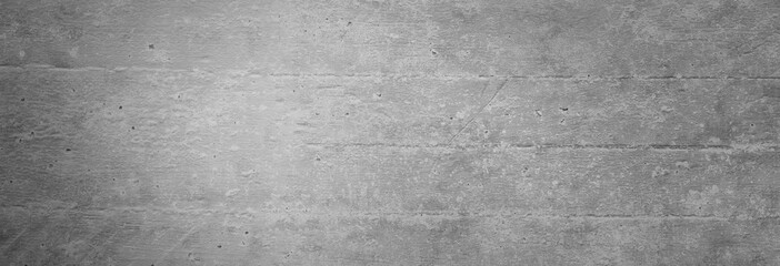 Textur einer grauen Betonwand als Hintergrund, auf der man die Abdrücke der Schalungsbretter noch sieht, was man als Linien nutzen kann - obrazy, fototapety, plakaty