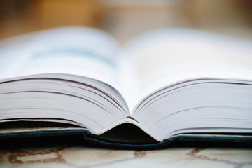 Education and wisdom concept - open book in library