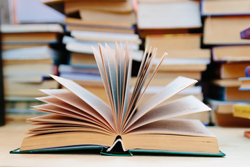 Education and wisdom concept - open book in library