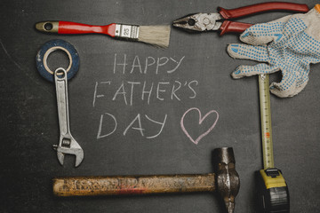 Set of different tools on dark background.A concept for Father's Day. Top view.