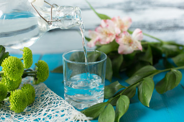 Water is poured into a glass from a bottle. Clean and fresh. Benefits for man