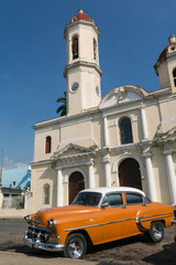 Old cars parked in the Jose Marti Park, in front of the Purisima Concepcion Cathedral. Cienfuegos, Cuba.