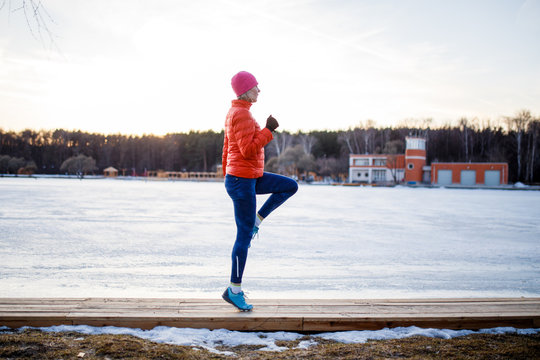 Potrtait of young athlete blonde at morning exercises in winter