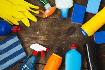 Cleaning products on wooden background. Home cleaning concept. Top view. From above. Copy space.