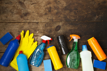 Cleaning products on wooden background. House cleaning concept. Top view. From above. Copy space.