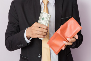 Businessman with money and orange wallet in studio . Business concept