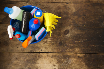 Cleaning products on wooden background. House cleaning concept. Top view. From above. Copy space.