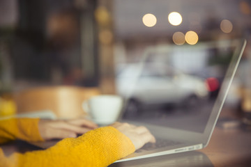 Close-up of female hands using laptop.