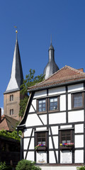 Altenburg / Germany: Timbered house in front of the so called Red Spires of the former collegiate church of the Virgin Mary