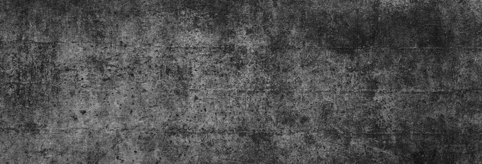 Obraz na płótnie Canvas Textur einer fast schwarzen, alten Betonwand in XXL-Größe als Hintergrund, auf die leichtes Licht fällt