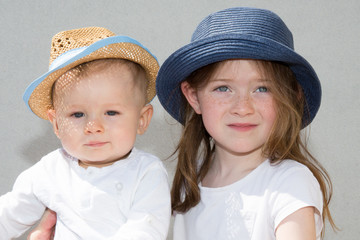 family child with sister and brother outdoor posing