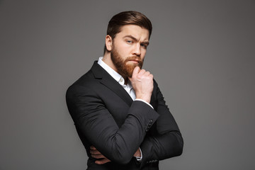 Portrait of a pensive young businessman dressed in suit