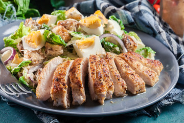 Healthy caesar salad with chicken, eggs and croutons