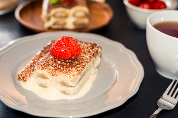 tiramisu cake decorated with strawberries Italian cuisine