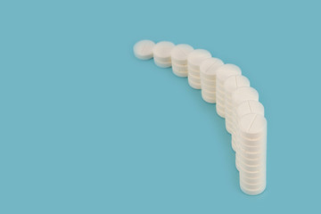 Curved row of columns with white tablets on a blue background.