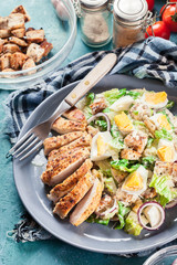 Healthy caesar salad with chicken, eggs and croutons