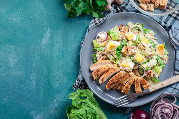 Healthy caesar salad with chicken, eggs and croutons - obrazy, fototapety, plakaty