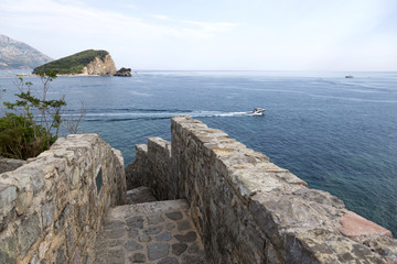 Fototapeta na wymiar BUDVA, MONTENEGRO - AUGUST 03, 2017:View of the coast from the observation deck of the ancient fortress Citadel