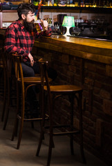 Guy spend leisure in bar, defocused background.