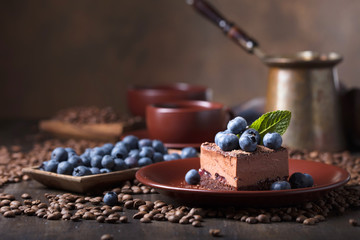 Chocolate cake with blueberries and mint .