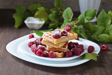 Waffles with raspberries .
