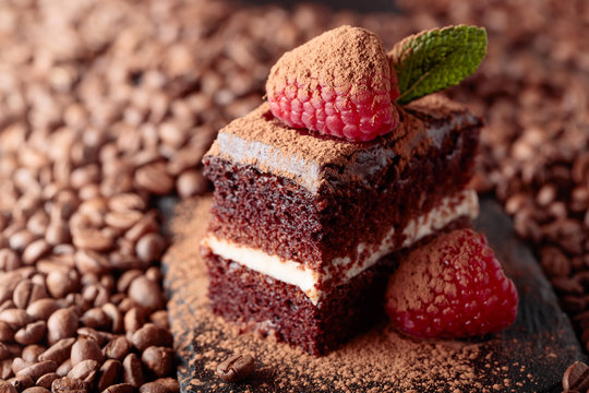 Closeup of chocolate cake with raspberry and mint .